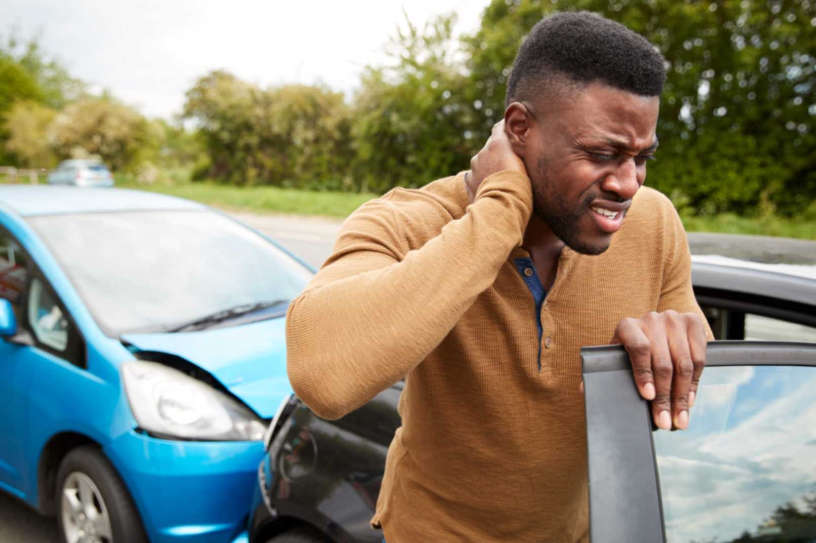 Christian Morris Trial Attorneys | Legal Blog Male Motorist With Whiplash Injury In Car Accident Getting Out Of Vehicle